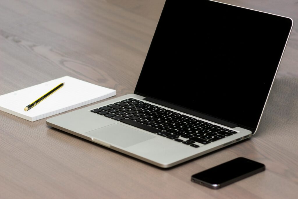 clean organized workspace with laptop notebook and phone for focused productivity